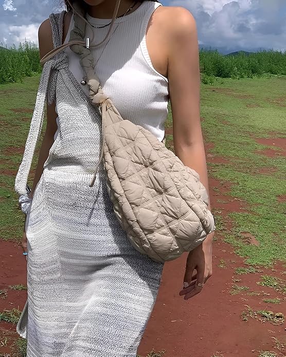 Side view of the bag showing the front zipper pocket and adjustable strap.