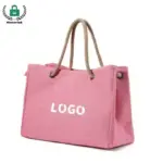 The Reusable Heavyweight Canvas Tote Bag features a pink design with rope handles and "LOGO" na frente, e está disponível para personalização OEM e ODM.