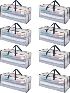 ແປດກະເປົາຂົນສົ່ງທີ່ມີຄວາມໂປ່ງໃສ, each labeled "BLANKETS" ແລະເຕັມໄປດ້ວຍຜ້າຫົ່ມພັບ, ປະກອບມີມືຈັບສີດໍາທີ່ແຂງ.