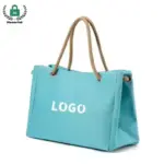 Reusable Heavyweight Canvas Tote Bag in light blue with rope handles and "LOGO" texto na frente, exibido em um fundo branco. Personalização OEM e ODM disponível.