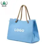 Light blue Reusable Heavyweight Canvas Tote Bag with rope handles and "LOGO" texto na frente, Perfeito para personalização OEM/ODM, mostrado em um fundo branco.