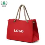Reusable Heavyweight Canvas Tote Bag in red with rope handles and "LOGO" texto impresso no lado, mostrado em um fundo branco. Marca personalizada oferecida por meio de serviços OEM e ODM.